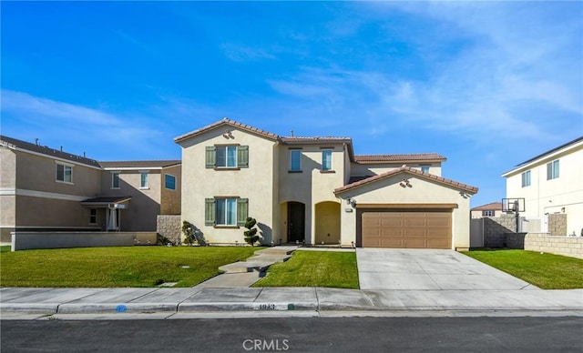 mediterranean / spanish-style house featuring a garage and a front lawn