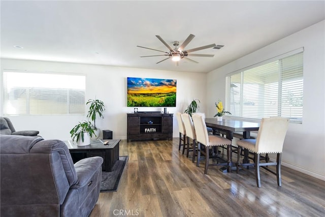 dining space featuring ceiling fan and dark hardwood / wood-style floors