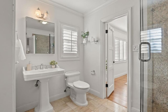 bathroom with tile patterned flooring, an enclosed shower, crown molding, and toilet