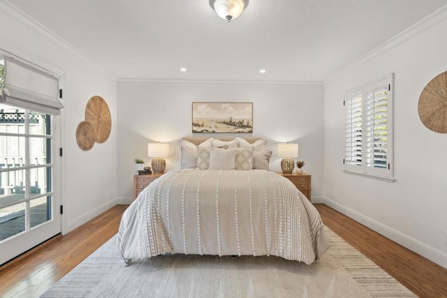 bedroom with ornamental molding, multiple windows, and light hardwood / wood-style flooring