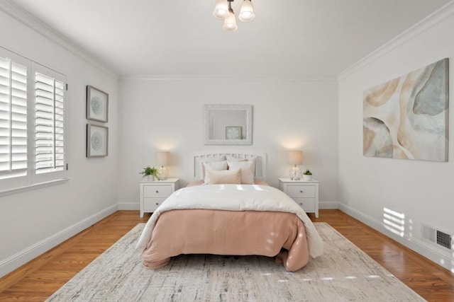 bedroom with hardwood / wood-style flooring and ornamental molding