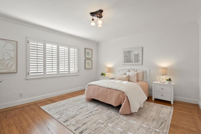 bedroom with crown molding and light wood-type flooring