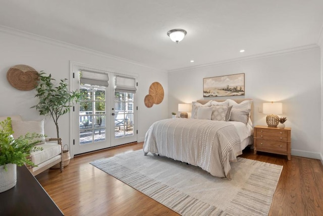 bedroom featuring hardwood / wood-style flooring, crown molding, access to outside, and french doors