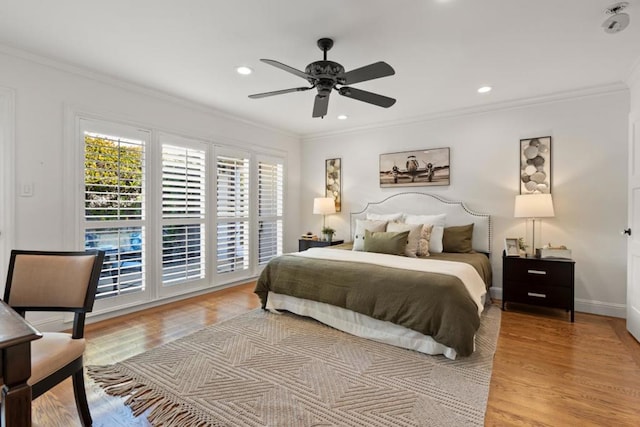 bedroom featuring light hardwood / wood-style flooring, ornamental molding, and ceiling fan