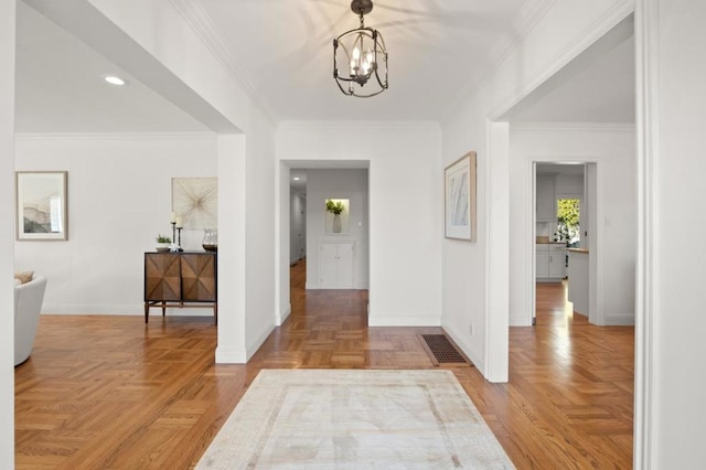 hall featuring parquet floors, crown molding, and a chandelier