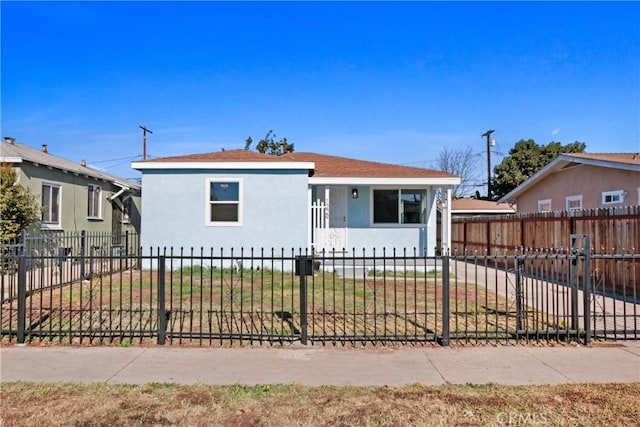 bungalow-style house with a front lawn