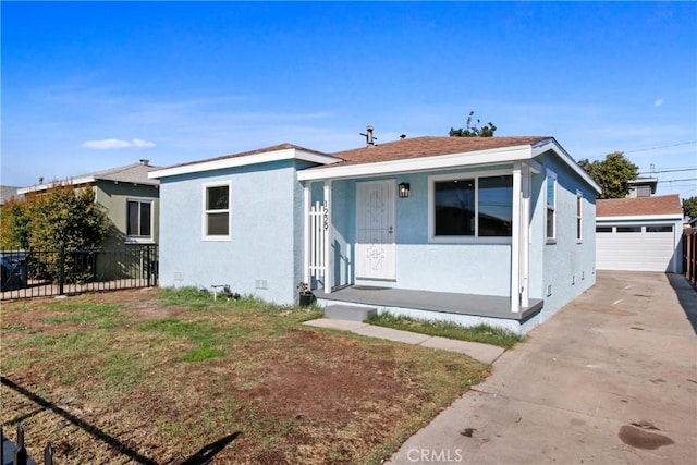 view of front of property featuring a garage and an outdoor structure