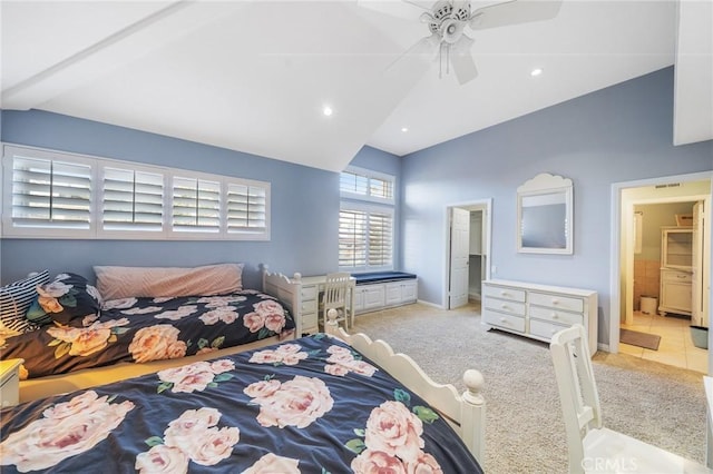 carpeted bedroom featuring ceiling fan, ensuite bathroom, and lofted ceiling