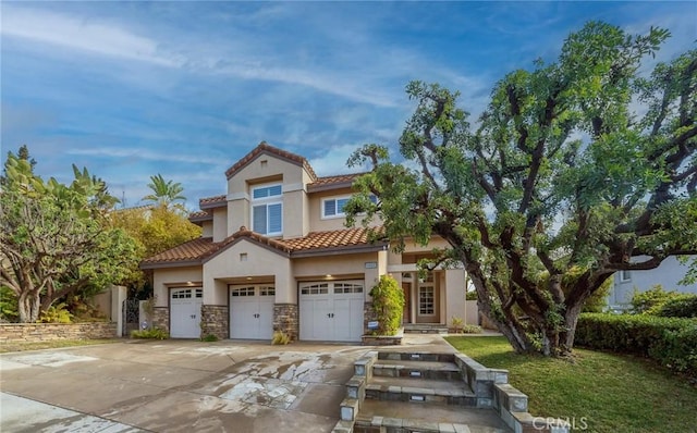 mediterranean / spanish house with a garage