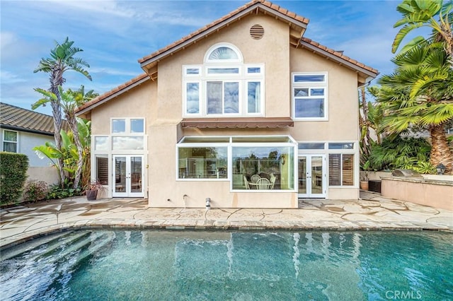 back of house with french doors and a patio area