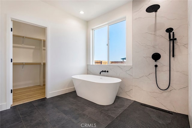 bathroom featuring shower with separate bathtub