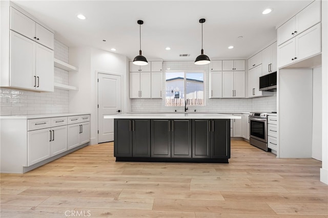 kitchen with white cabinetry, stainless steel electric range oven, a center island, and pendant lighting