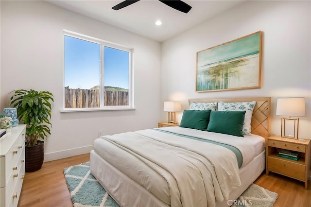 bedroom with ceiling fan and light hardwood / wood-style flooring