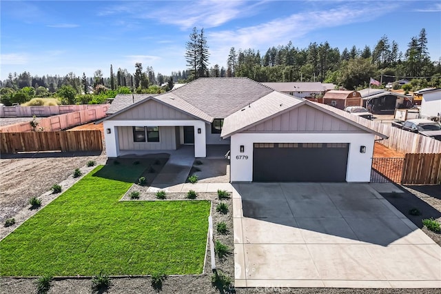 view of front of property featuring a garage and a front yard