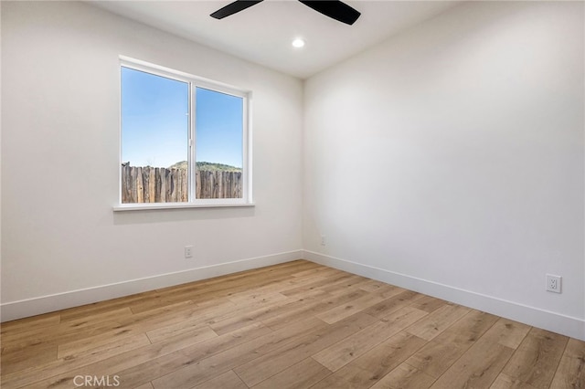 unfurnished room with ceiling fan and light hardwood / wood-style flooring