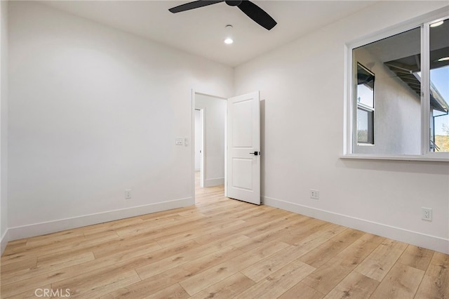 unfurnished room with ceiling fan and light hardwood / wood-style flooring