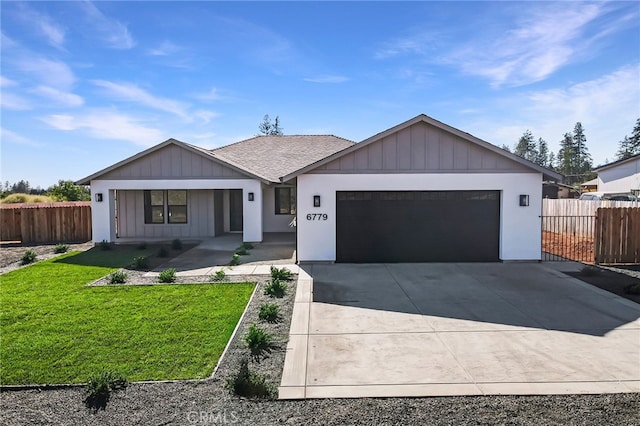 view of front of house featuring a garage and a front lawn