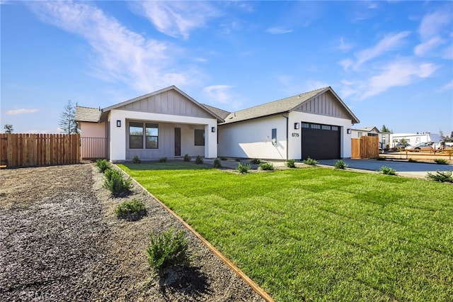 view of front of property with a garage and a front lawn