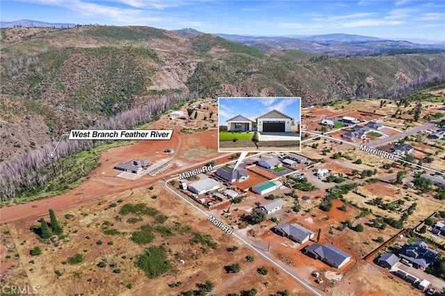 birds eye view of property featuring a mountain view