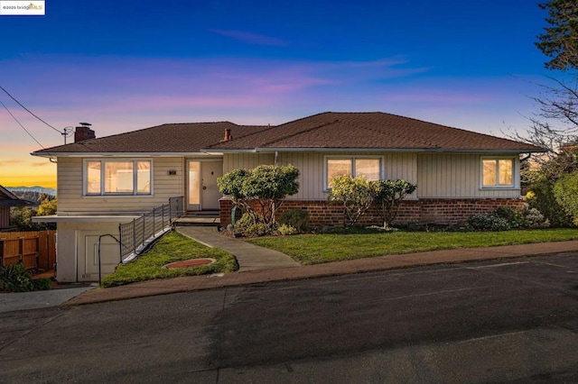 view of front of house with a yard and a garage