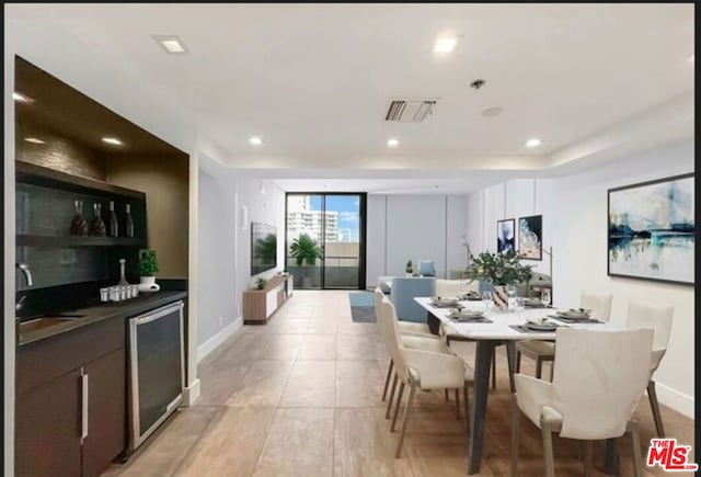 dining area featuring wine cooler and indoor wet bar