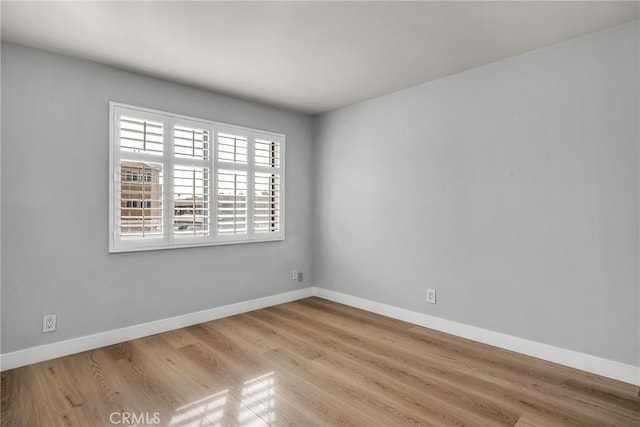 empty room with light hardwood / wood-style flooring