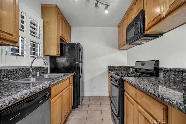 kitchen with light tile patterned flooring, dark stone countertops, sink, and black appliances