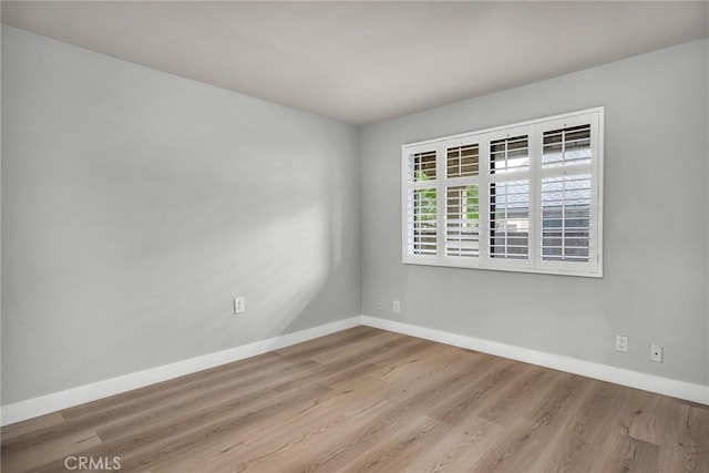 spare room with light hardwood / wood-style floors