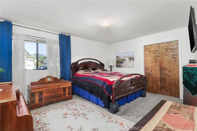 carpeted bedroom featuring a textured ceiling