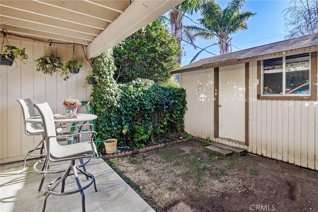 view of patio featuring a storage shed