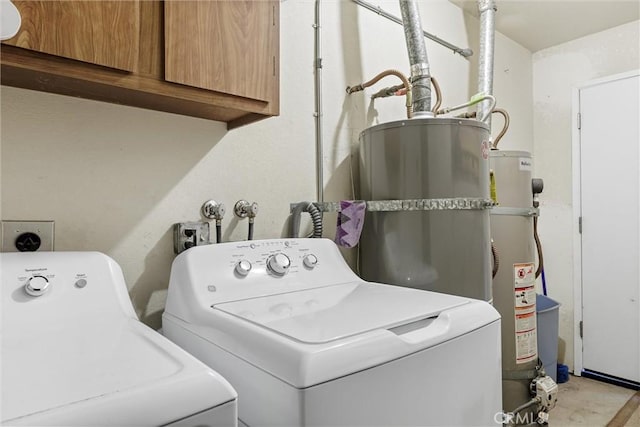 laundry room with cabinets, washing machine and dryer, gas water heater, and secured water heater