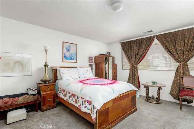 carpeted bedroom with a textured ceiling