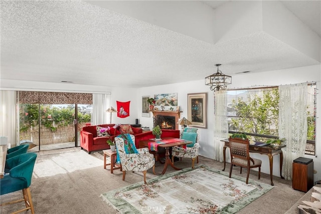 carpeted living room with a textured ceiling and an inviting chandelier