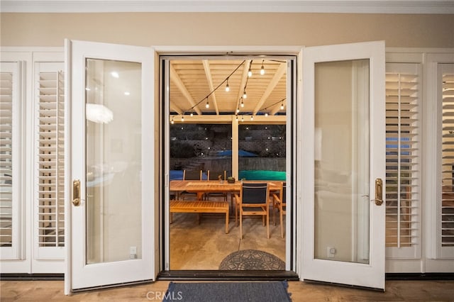 doorway to outside featuring rail lighting