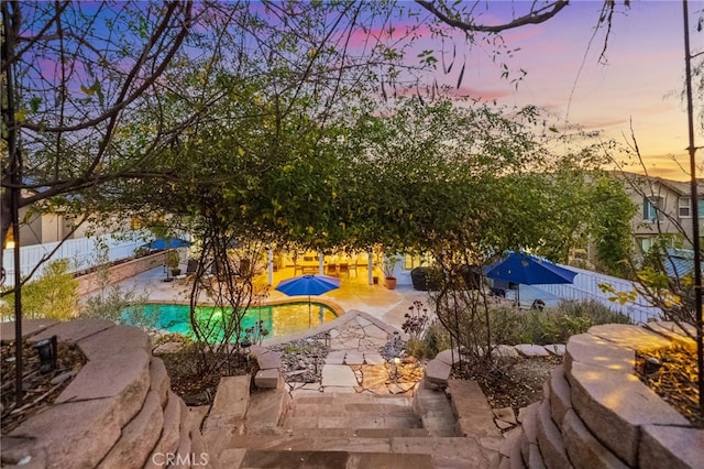 view of patio terrace at dusk