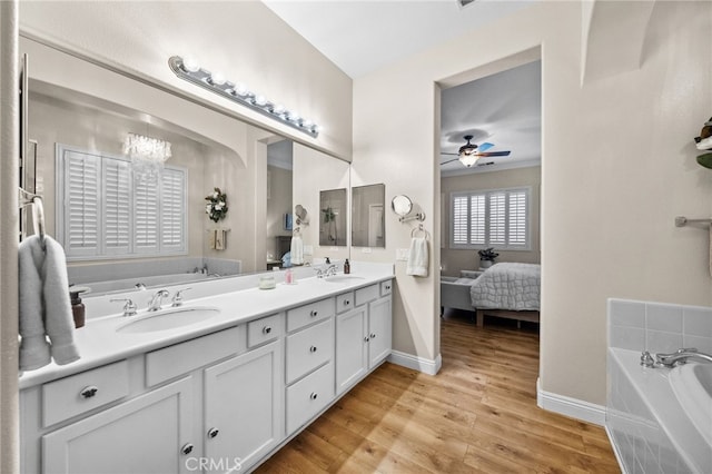 bathroom with vanity, a washtub, wood-type flooring, and ceiling fan