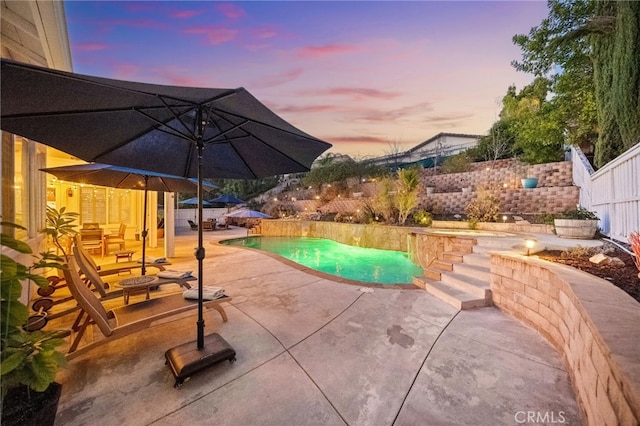 pool at dusk with a patio