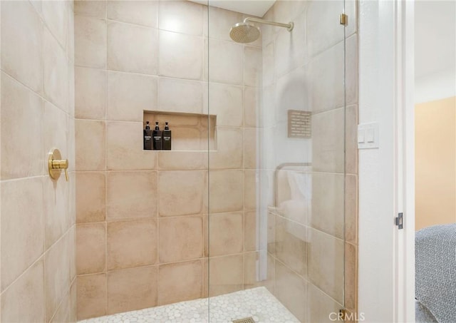 bathroom with tiled shower