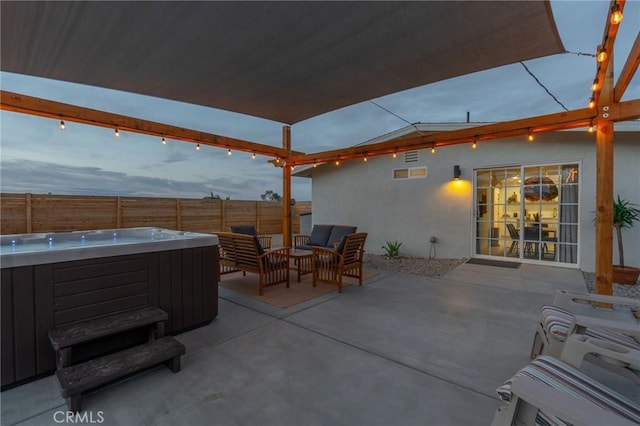 patio terrace at dusk with a hot tub