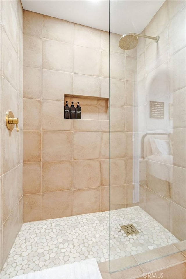 bathroom with tiled shower