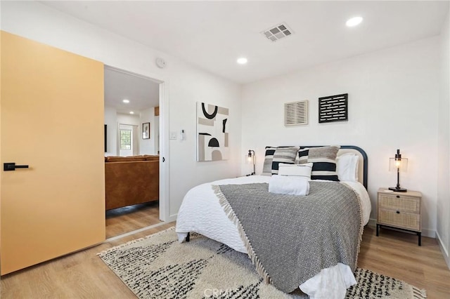 bedroom with hardwood / wood-style floors