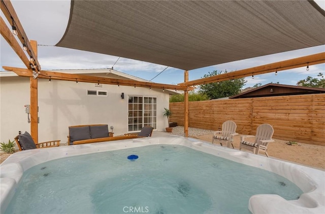 view of swimming pool featuring a hot tub