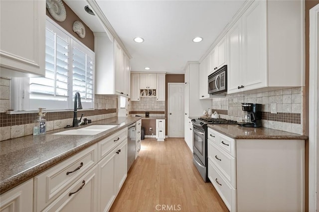 kitchen with white cabinetry, sink, light hardwood / wood-style flooring, and stainless steel appliances