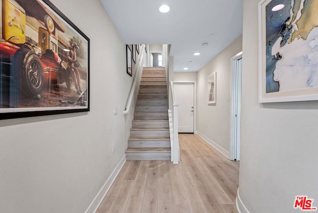 hallway with light hardwood / wood-style flooring