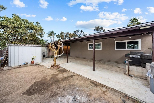 exterior space with a storage unit and a grill