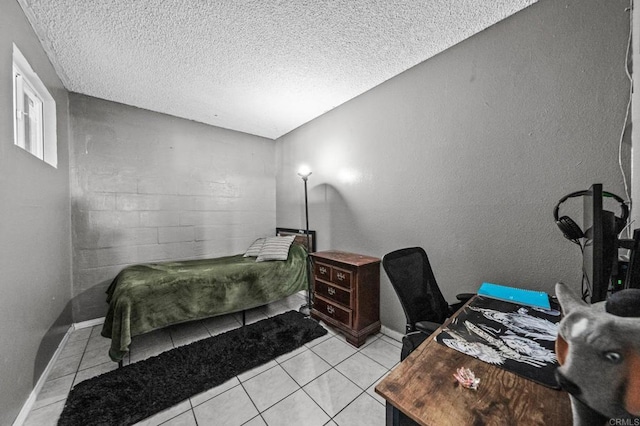 bedroom featuring light tile patterned floors and a textured ceiling