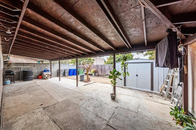 view of patio with a storage shed