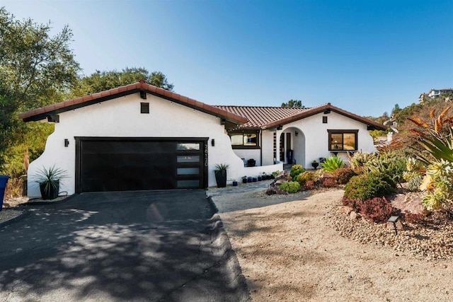 mediterranean / spanish house with a garage