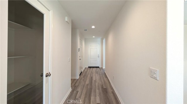 hallway with wood-type flooring