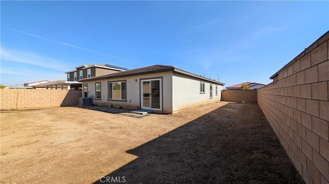 rear view of house with central AC